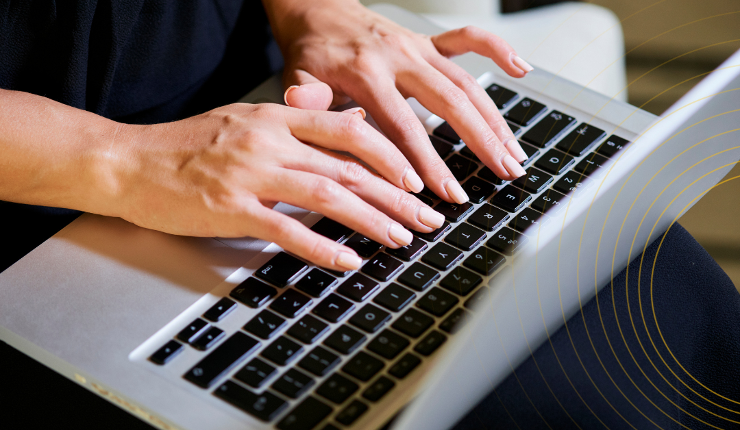 Woman writing CV on laptop